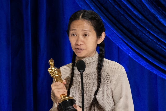 Chloe Zhao collecting the Best Director award