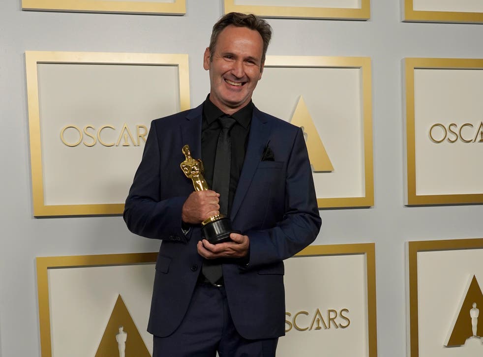 <p>Scott R Fisherwith the award for best visual effects for ‘Tenet’</p>