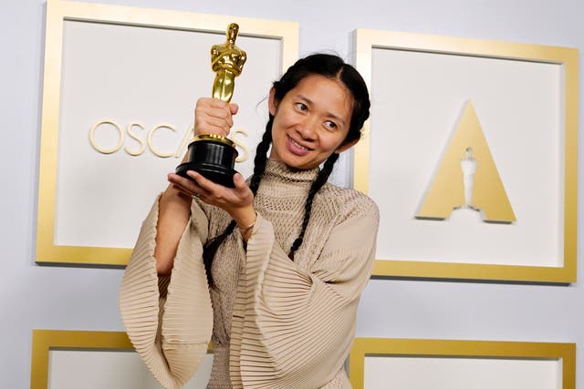 Chloé Zhao poses after winning the Academy Award for Best Picture for Nomadland