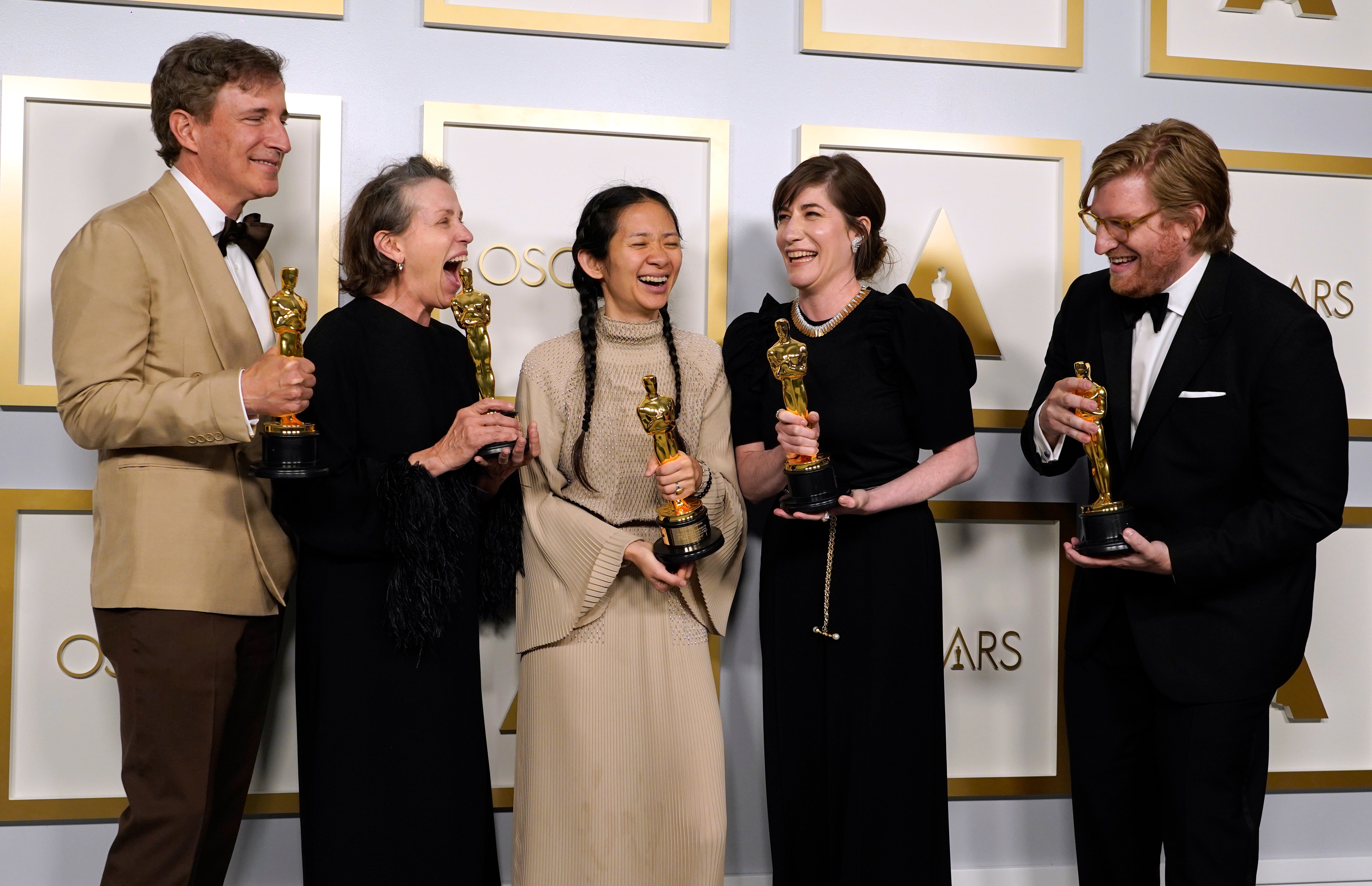 Producers Peter Spears, from left, Frances McDormand, Chloe Zhao, Mollye Asher and Dan Janvey, winners of the award for best picture for ‘Nomadland’