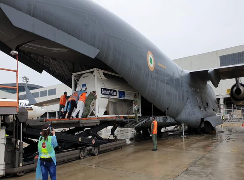 <p>An oxygen tank is loaded onto an aircraft to supply hospitals in India, at Changi Airport in Singapore</p>