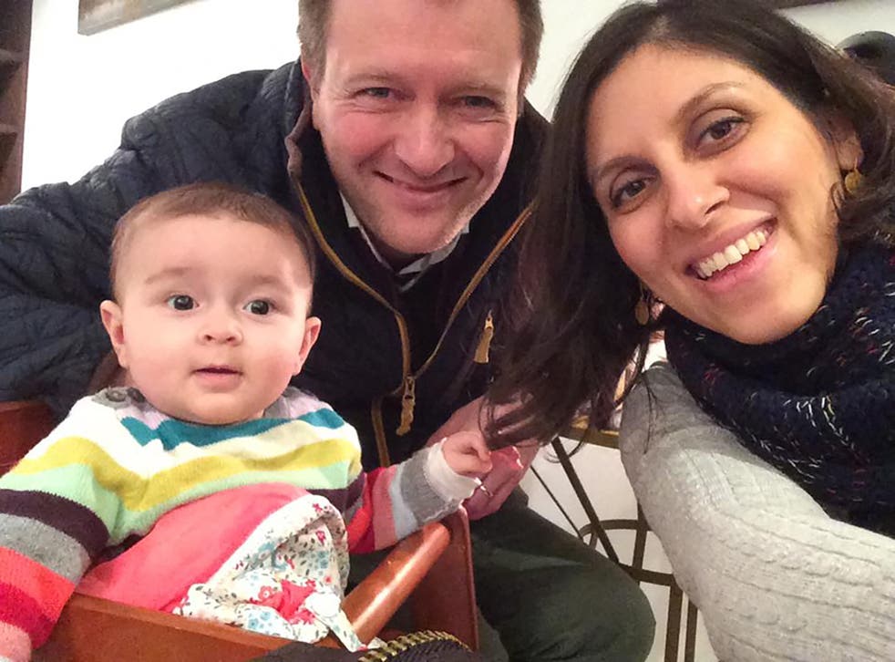 Nazanin Zaghari-Ratcliffe (R) posing for a photograph with her husband Richard and daughter Gabriella