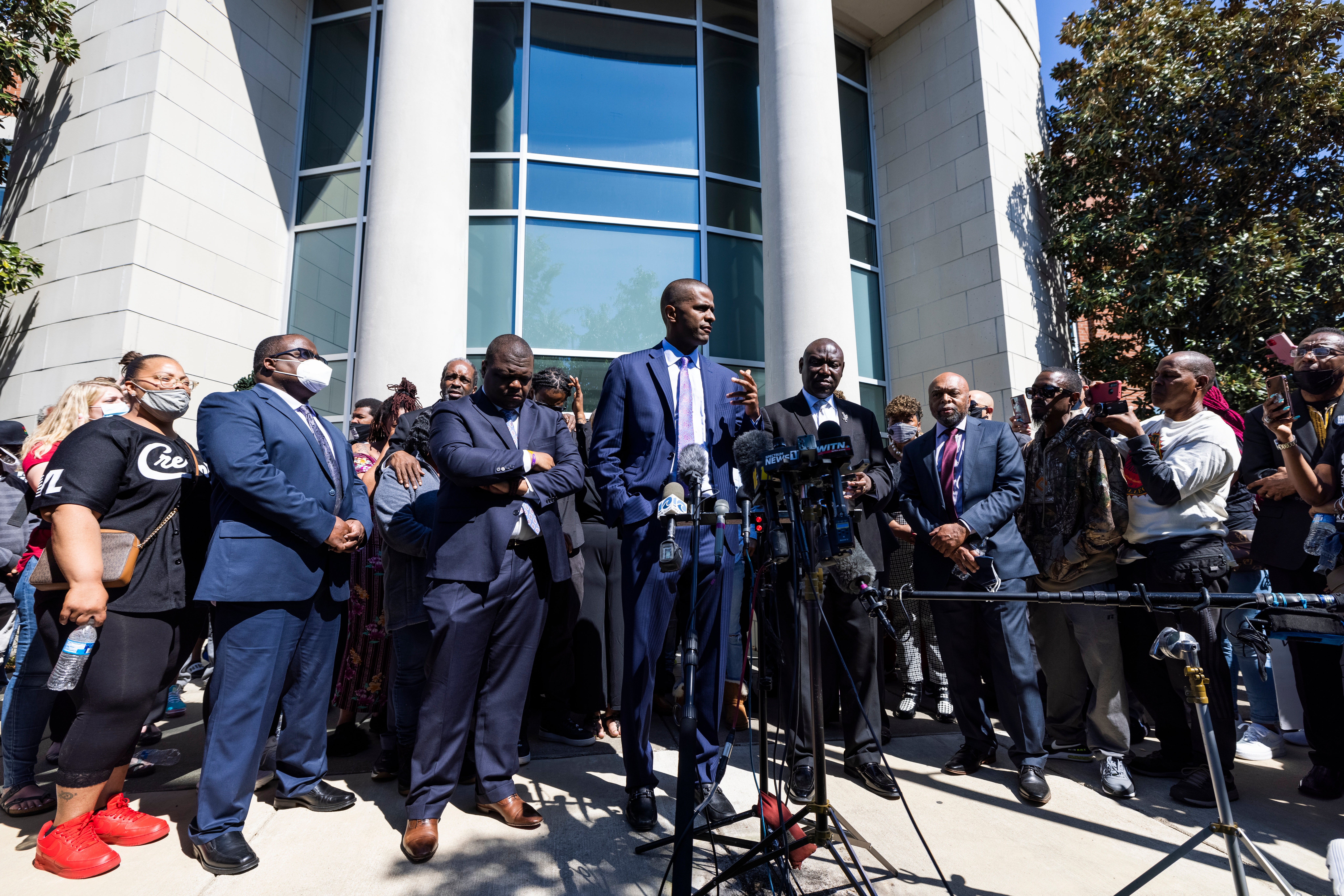 <p>ELIZABETH CITY, NC - APRIL 24:  Demonstrators hold signs during a protest march on April 24, 2021 in Elizabeth City, North Carolina. Protestors called for the release of body camera footage from the shooting death of Andrew Brown Jr. on April 21. </p>
