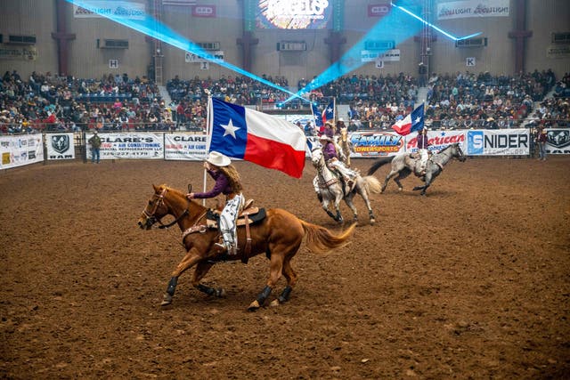 Riders carry the Texas state flag during the opening ceremony of the San Angelo Stock Show and Rodeo, April 16, 2021 in San Angelo. The Lone Star state will get two new congressional representatives as a result of the latest census