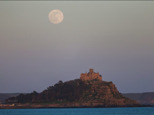 The supermoon rises above St Michael’s Mount on 26 April 2021 in Penzance, England