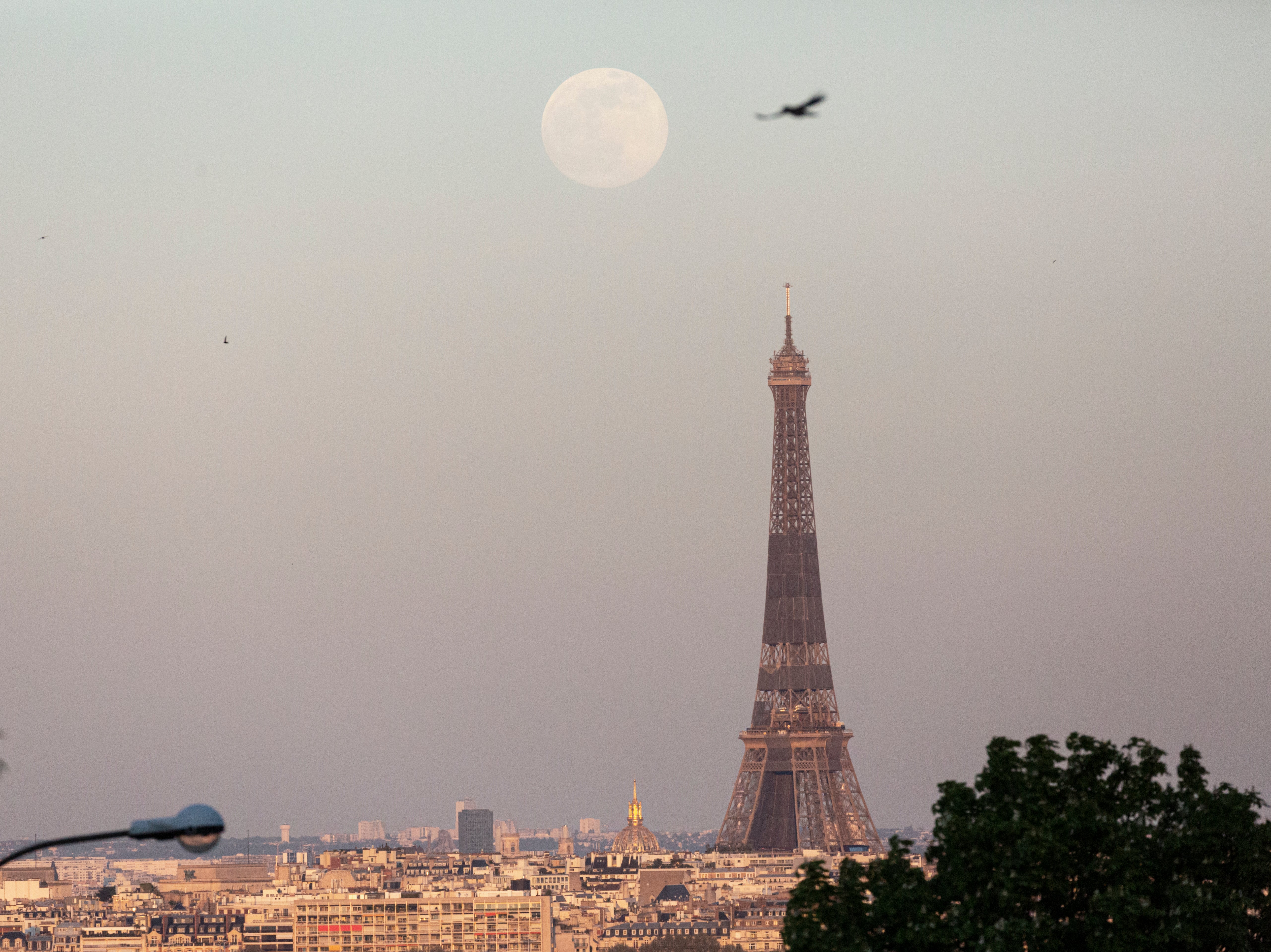 A supermoon rises over the Eiffel Tower on 26 April 2021 in Paris, France