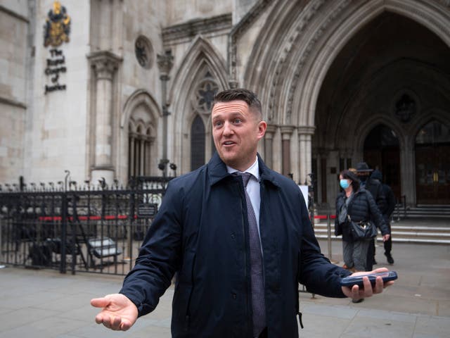 Tommy Robinson gestures outside the Royal Courts of Justice, London, for the libel case brought against him by Jamal Hijazi