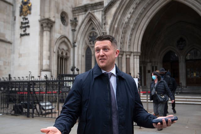Tommy Robinson gestures outside the Royal Courts of Justice, London, for the libel case brought against him by Jamal Hijazi