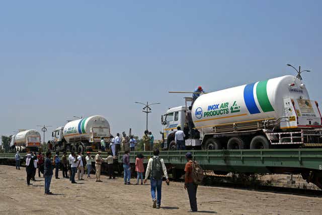 <p>Oxygen tankers being boarded on a special ‘oxygen’ train at a goods yard in Navi Mumbai </p>