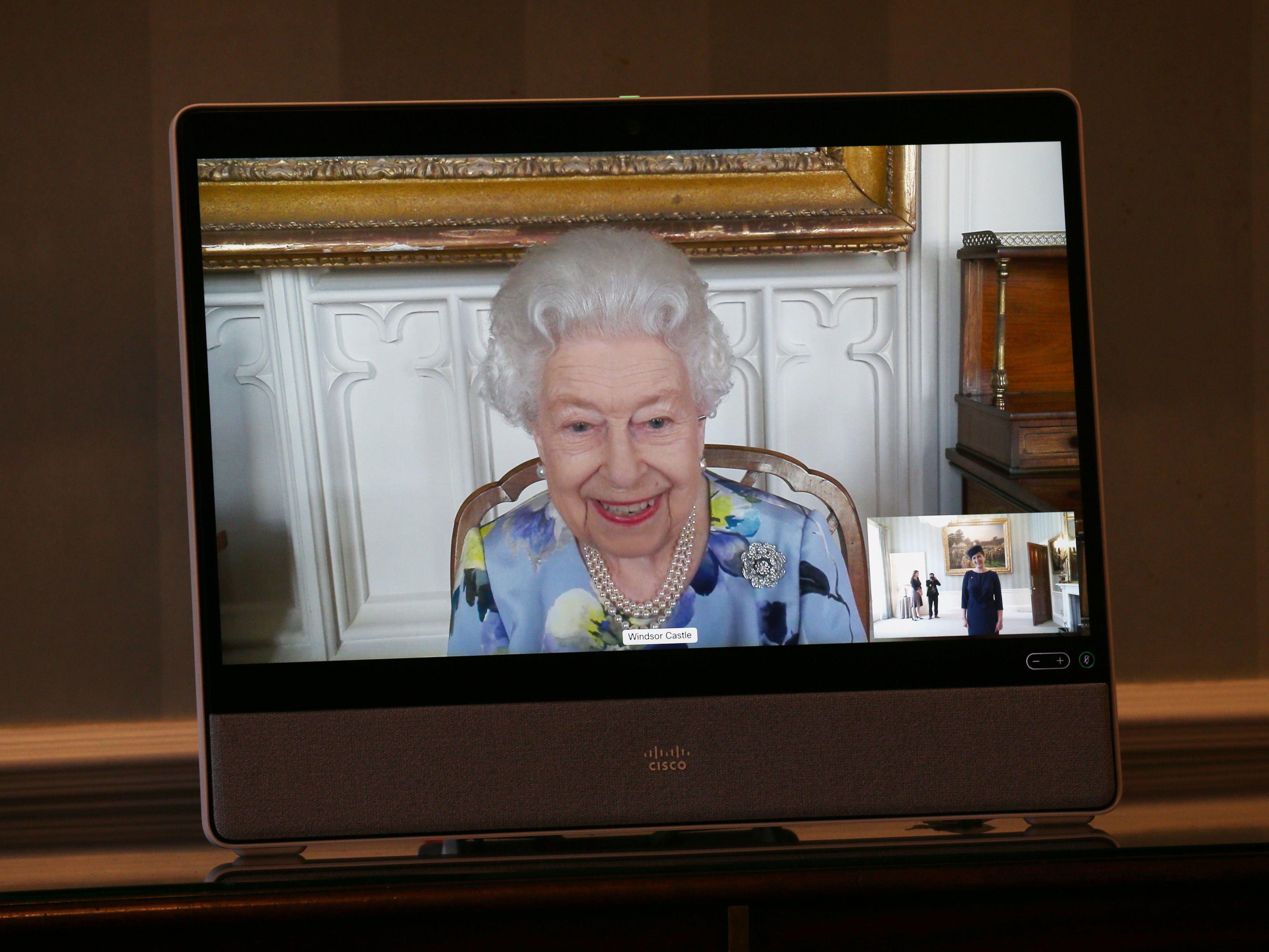 Queen Elizabeth appears on a screen by video-link from Windsor Castle on 27 April
