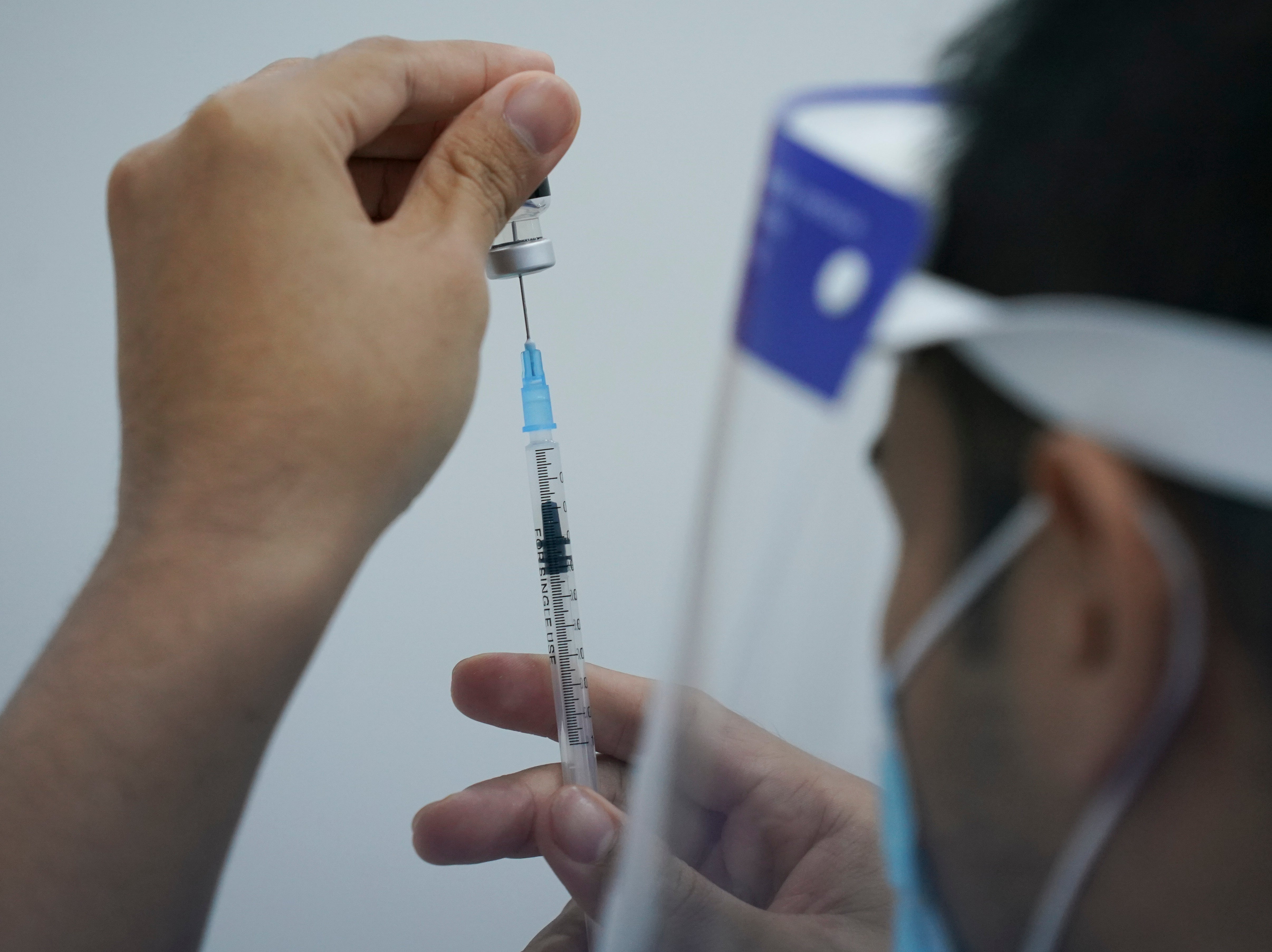 File photo: A health worker prepares to administer Pfizer’s Covid-19 vaccine at a vaccination center in Subang Jaya, Malaysia