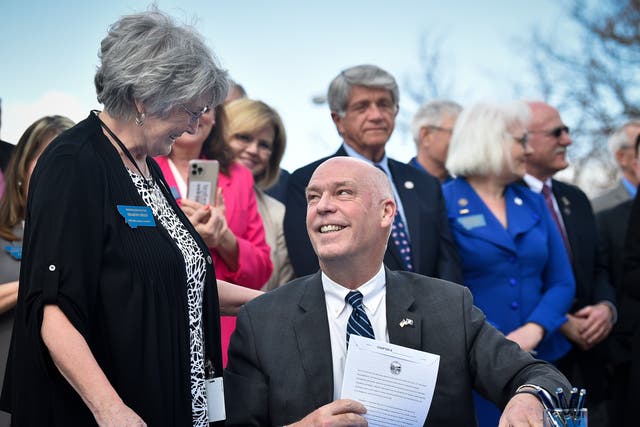 Republican Gov. Greg Gianforte smiles at Rep. Sharon Greef, R-Florence, during the signing of a bill in Helena, Mont. Monday, April 26, 2021. 