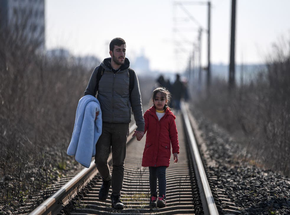 Migrants walk on railways toward Meritsa river, near Edirne, to take a boat to attempt to enter Greece by crossing the river on March 1, 2020. KS, a father of three young children had tried to cross into Greece from Turkey with his own family.