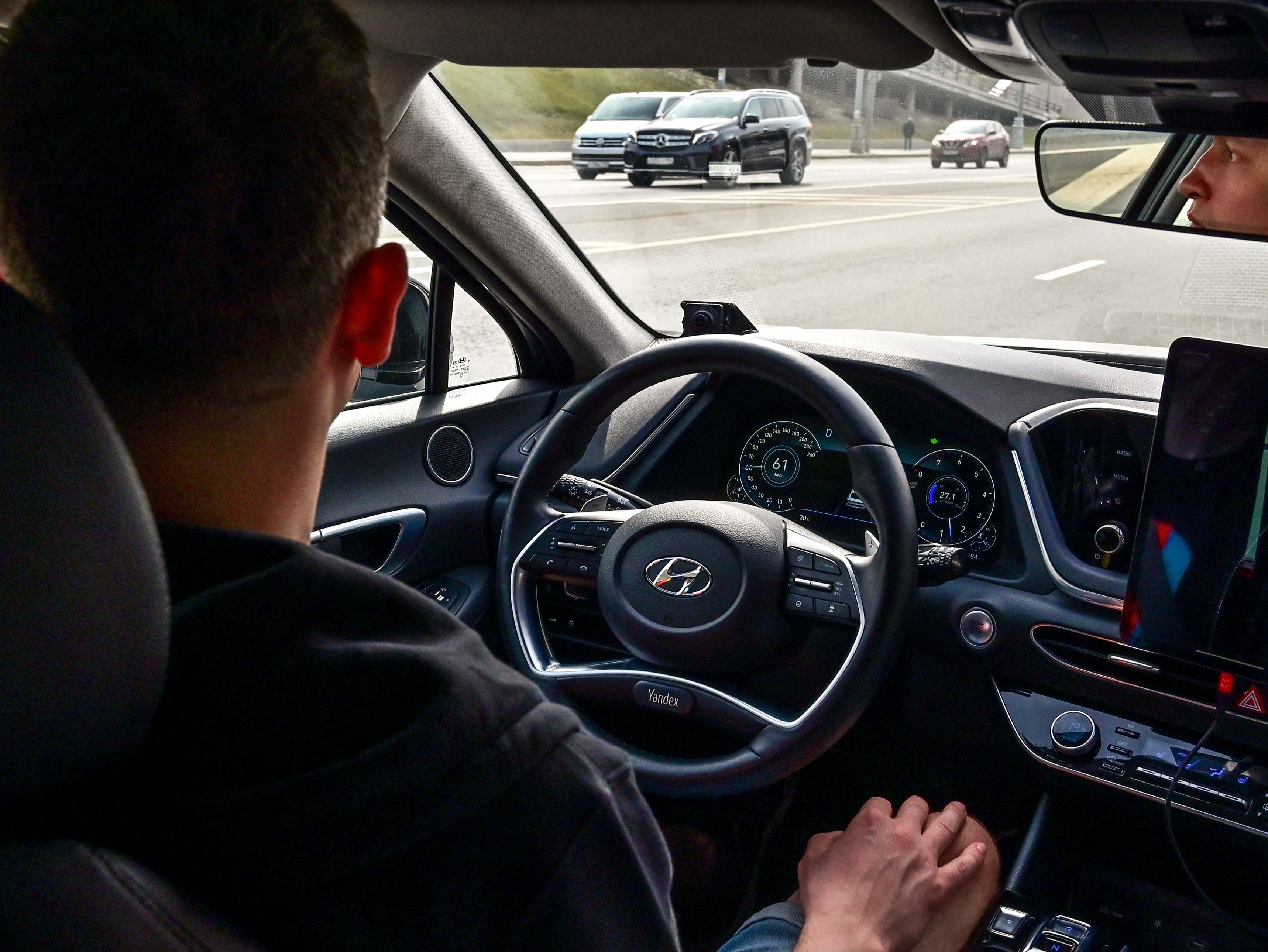 An engineer keeps his hands on his knees in a self-driving car, developed by Russian internet giant Yandex