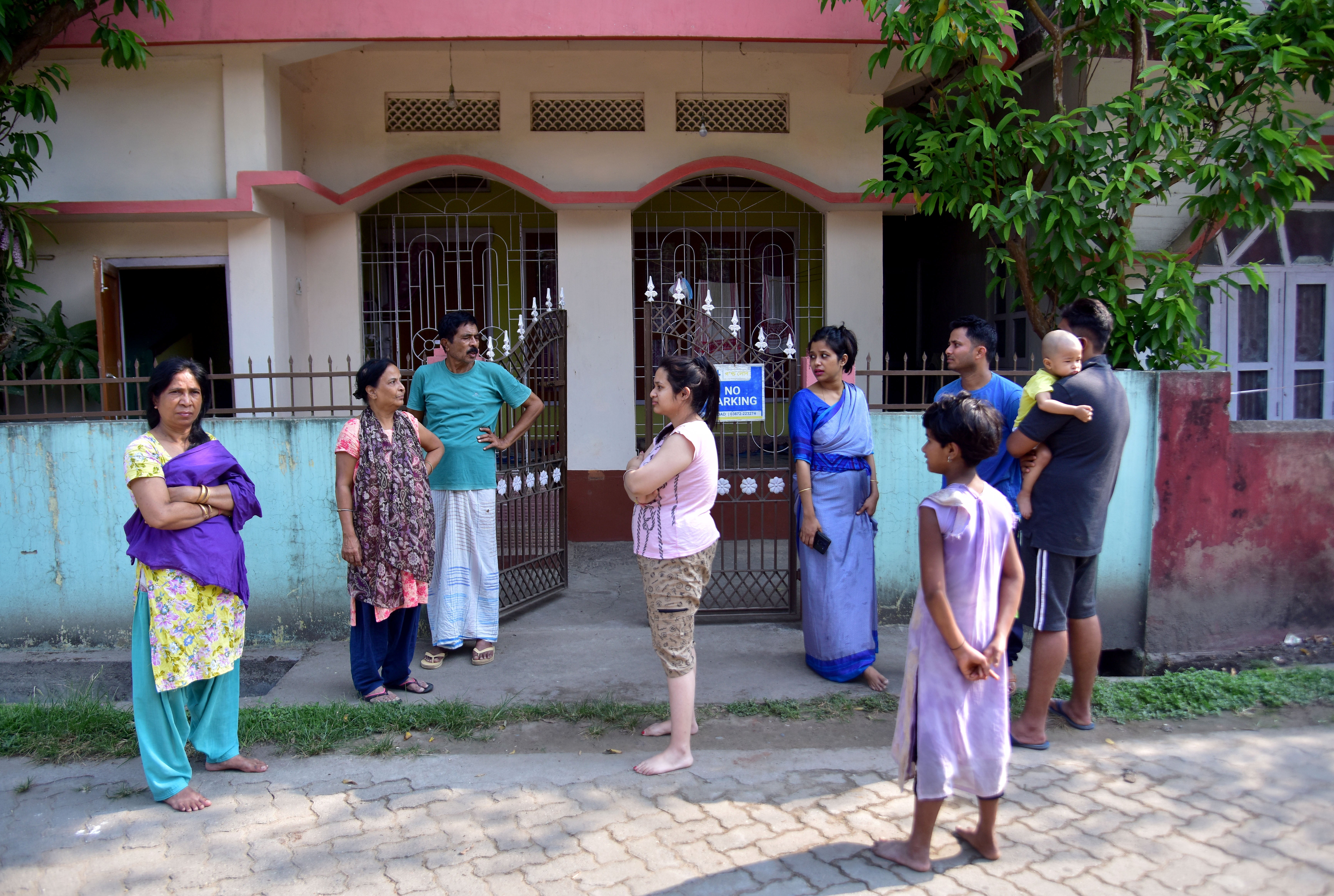 Residents are seen after vacating their houses following an earthquake in Nagaon district, Assam