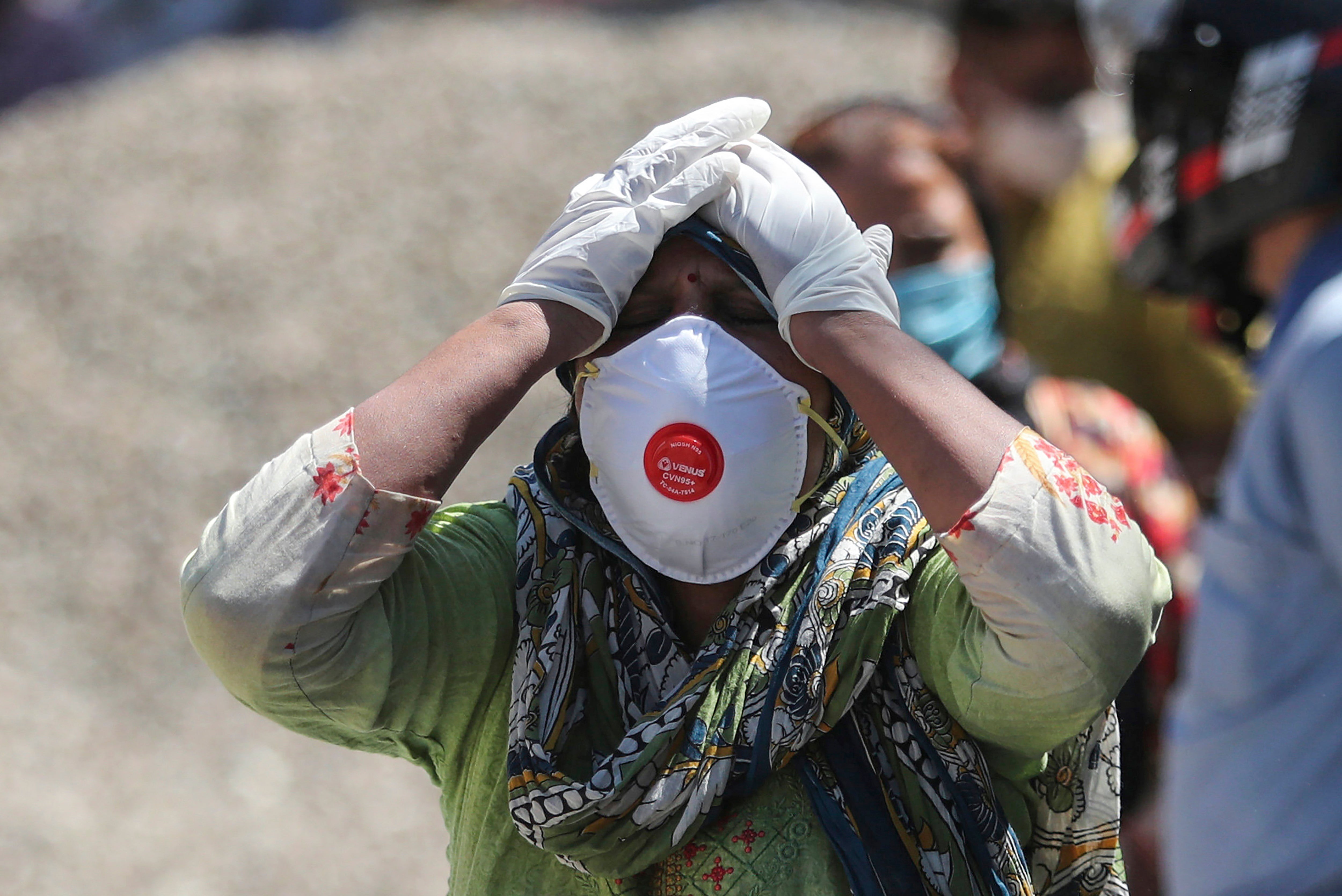 A relative of a person who died of Covid-19 reacts at a crematorium in Jammu, India