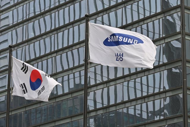<p>File image: A Samsung flag and South Korean national flag flutter at the company’s Seocho building in Seoul</p>