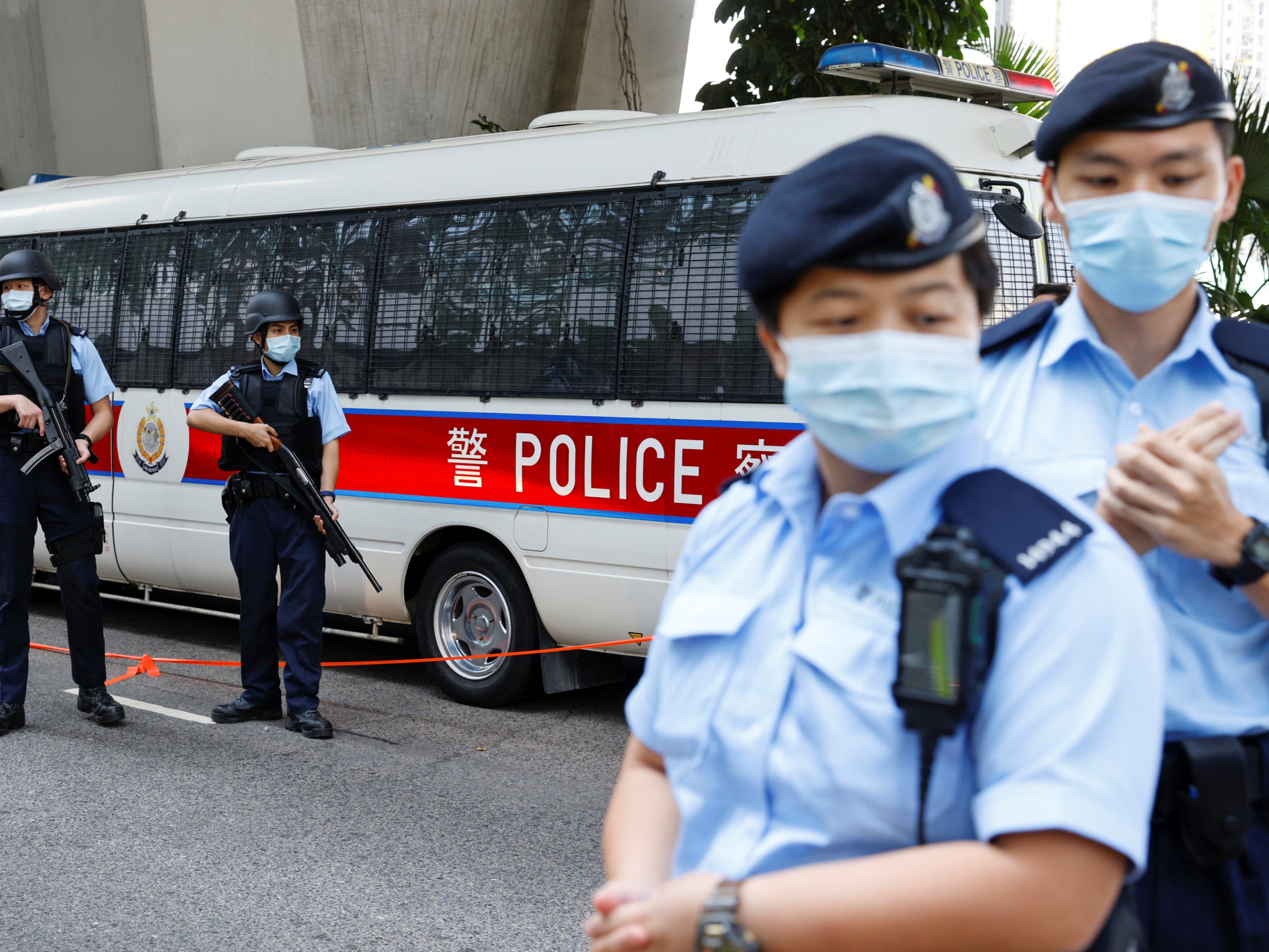 <p>Armed police stand guard as a prison van leaves West Kowloon Magistrates’ Courts in Hong Kong</p>