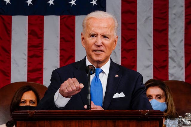 <p>US President Joe Biden addresses a joint session of Congress as Vice President Kamala Harris (L) and Speaker of the House Nancy Pelosi look on in the House chamber of the US Capitol 28 April 2021 in Washington, DC</p>