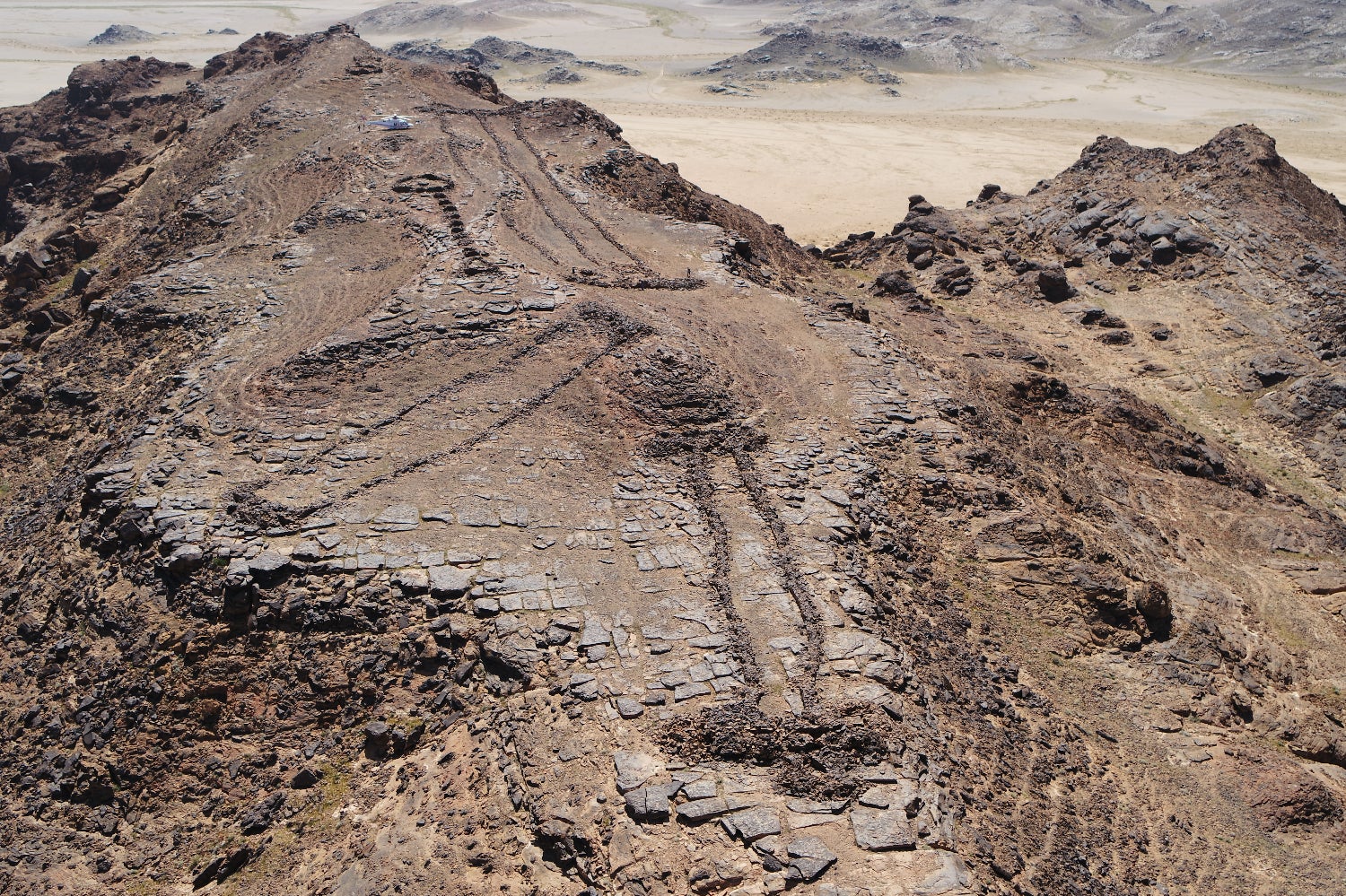 Three monumental mustatils and a later funerary ‘pendant’ located atop a rocky outcrop on the border of Khaybar and AlUla counties.