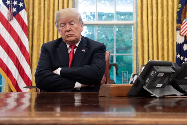 <p>US President Donald Trump sits at the Resolute Desk during a briefing on Hurricane Michael in the Oval Office of the White House in Washington, DC, on 10 October 2018</p>