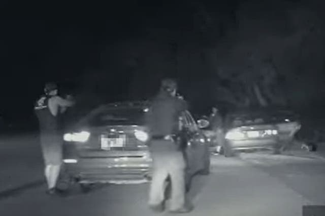 <p>A still from an Austin patrol car dash cam shows Texas officers holding Alex Gonzales at gun point in January after an alleged road rage incident. Mr Gonzales was shot ten times and died at the scene. </p>