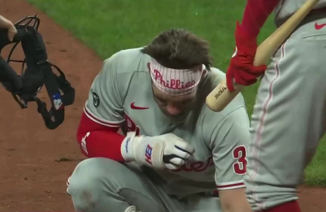 Bryce Harper recovers after being hit in the face with a fastball pitch