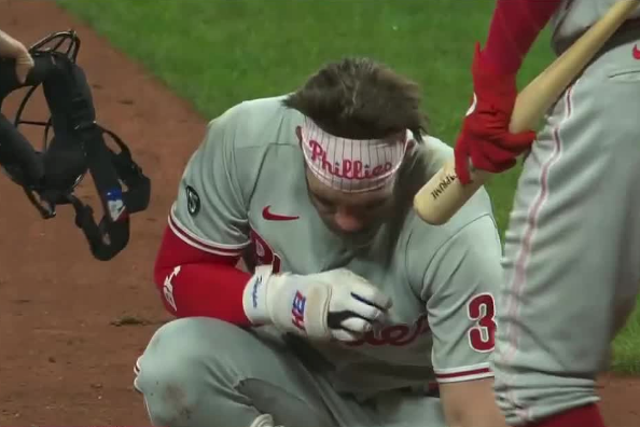 Bryce Harper recovers after being hit in the face with a fastball pitch