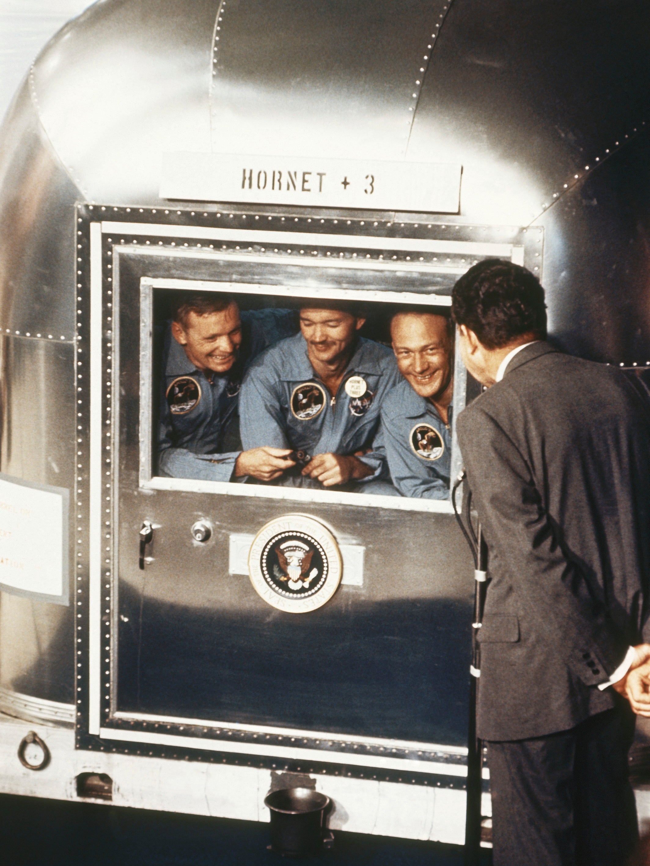 Richard Nixon greets the Apollo 11 astronauts after their return to Earth