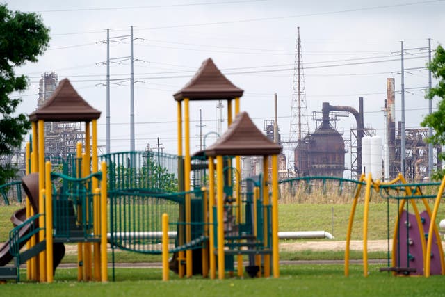 <p>In this Monday, March 23, 2020 file photo, a playground outside the Prince Hall Village Apartments sits empty near one of the petrochemical facilities in Port Arthur, Texas. According to a study published Wednesday, April 28, 2021 in the journal Science Advances,  across America, people of color are disproportionately exposed to air pollution from industry, vehicles, construction and many other sources. (AP Photo/David J. Phillip)</p>