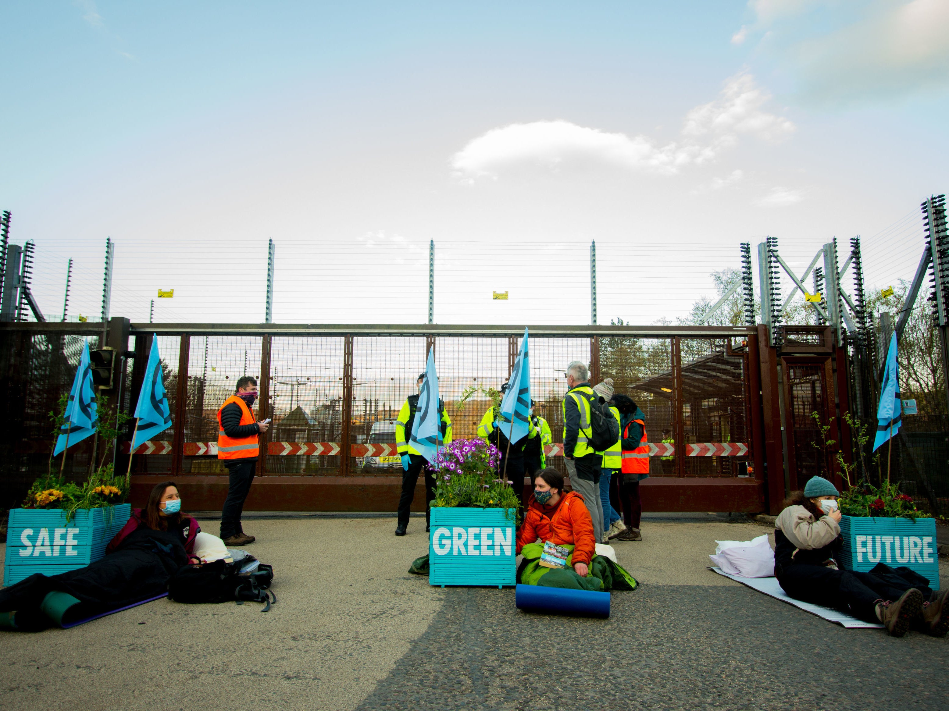 <p>Activists placed three giant plant pots, filled with plants and flowers, on the road on Friday morning</p>