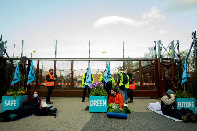 <p>Activists placed three giant plant pots, filled with plants and flowers, on the road on Friday morning</p>