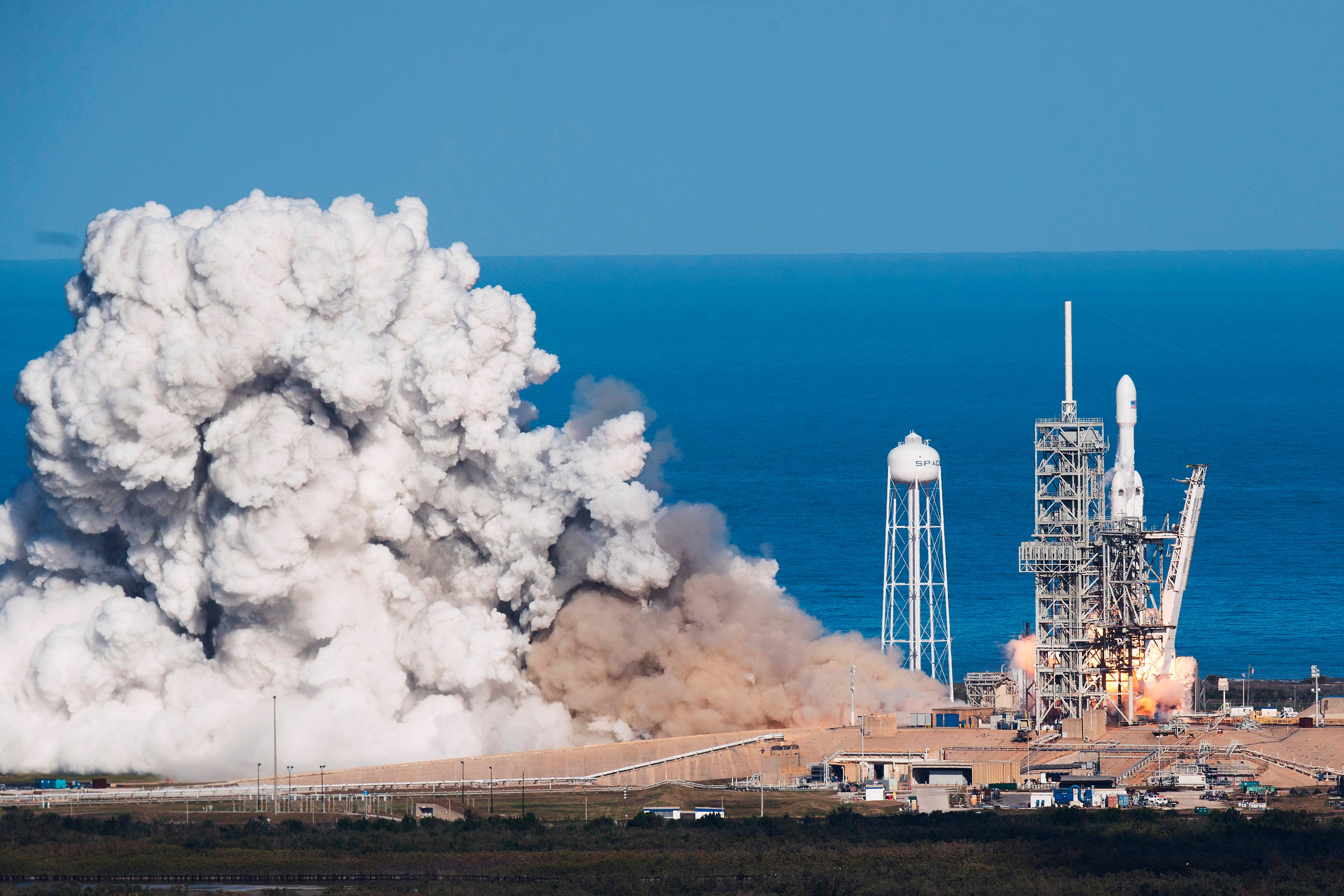 SpaceX's Falcon Heavy blasts off in 2018, carrying a Tesla roadster to an orbit near Mars