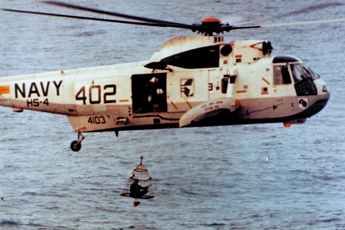 An astronaut is winched to safety during the Apollo 13 recovery operation in 1970. The third Apollo manned-mission to the moon was cancelled due to onboard explosion. The crew survived