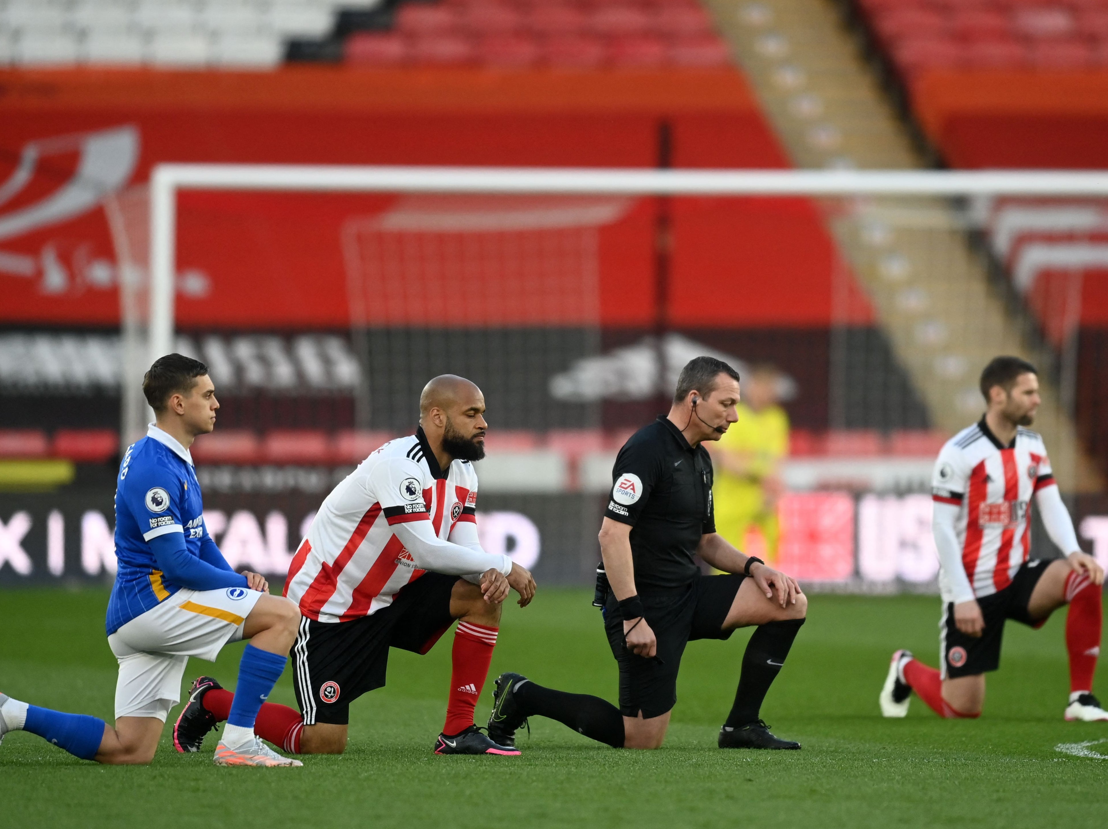 Players take a knee in support of the No Room For Racism campaign