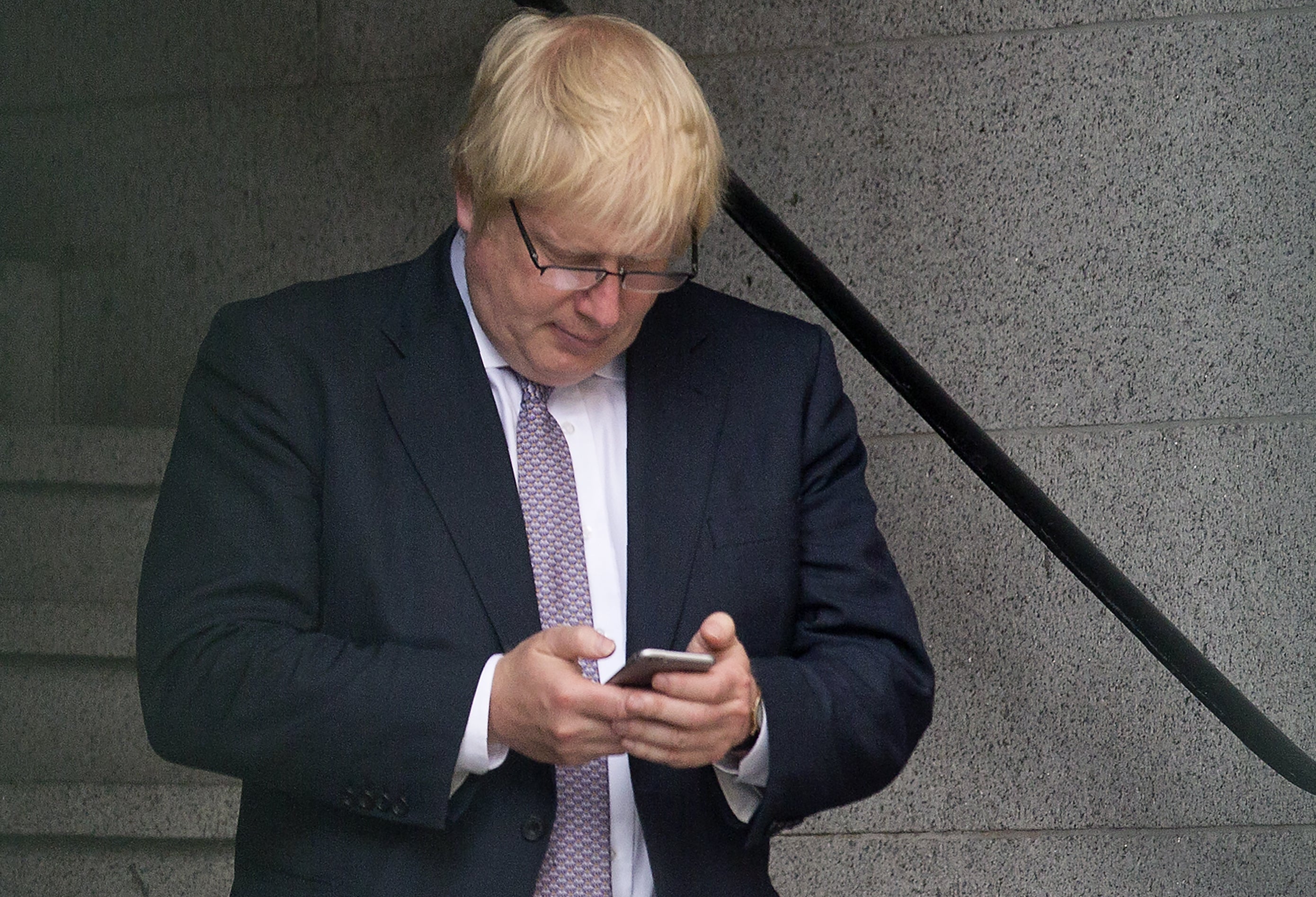 On call: Boris Johnson checks his mobile phone in 2016