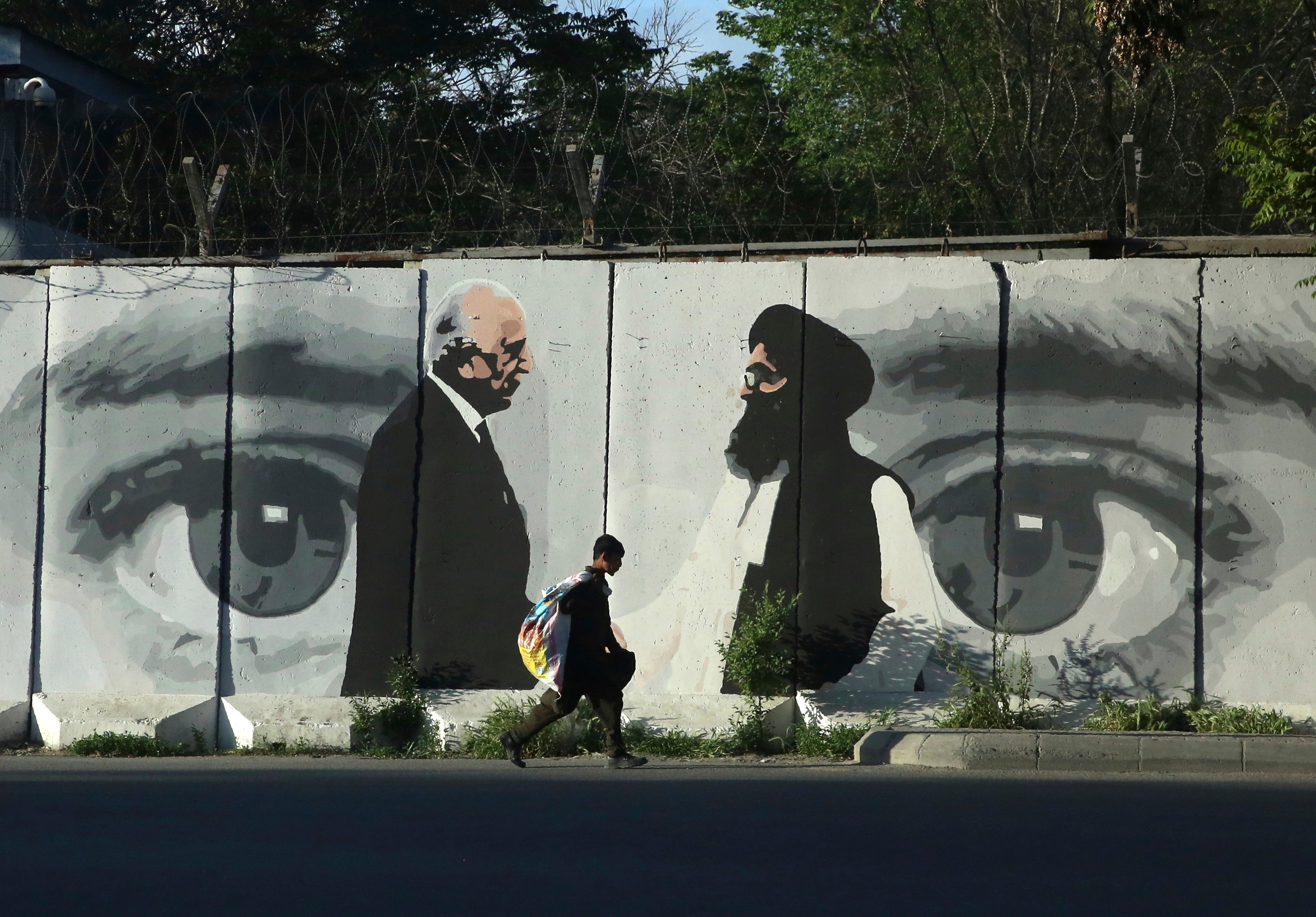 Graffiti in Kabul depicts US peace envoy Zalmay Khalilzad, left, and Mullah Abdul Ghani Baradar, Taliban representative