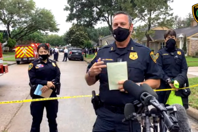 Houston Police’s Daryn Edwards outside a home where 91 people were found in possible human smuggling case