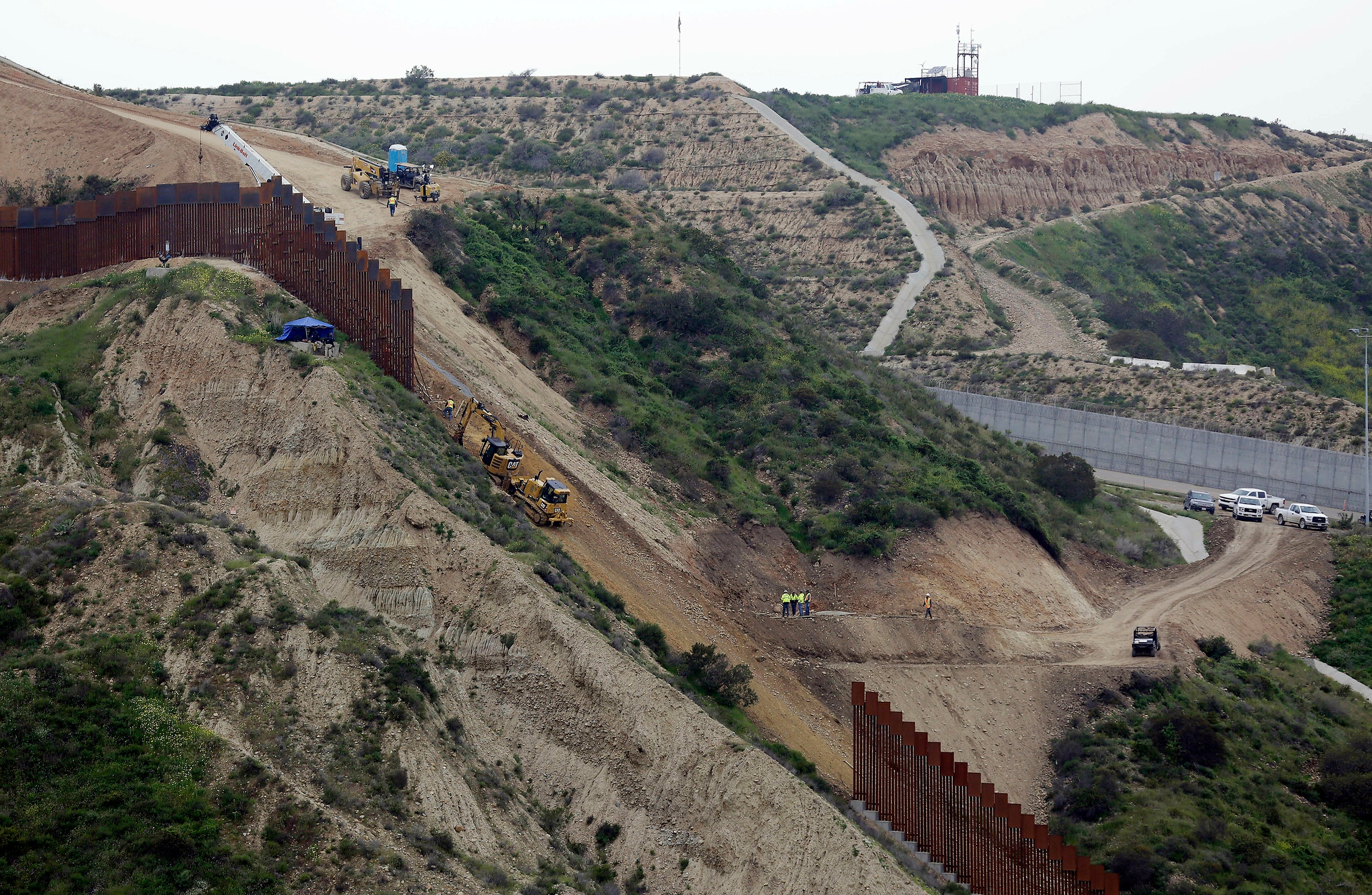 Construction crews replace a section of the primary wall separating San Diego and Tijuana, Mexico, in March 2019