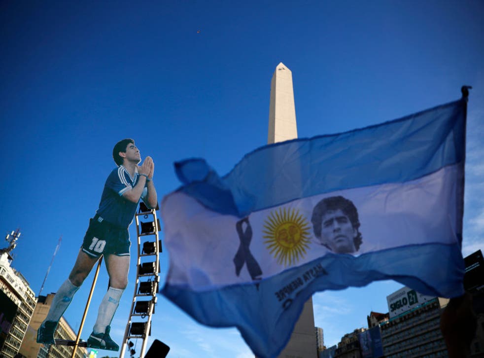 <p>Flags and cut-outs of Maradona have been prominent in fans’ protests</p>