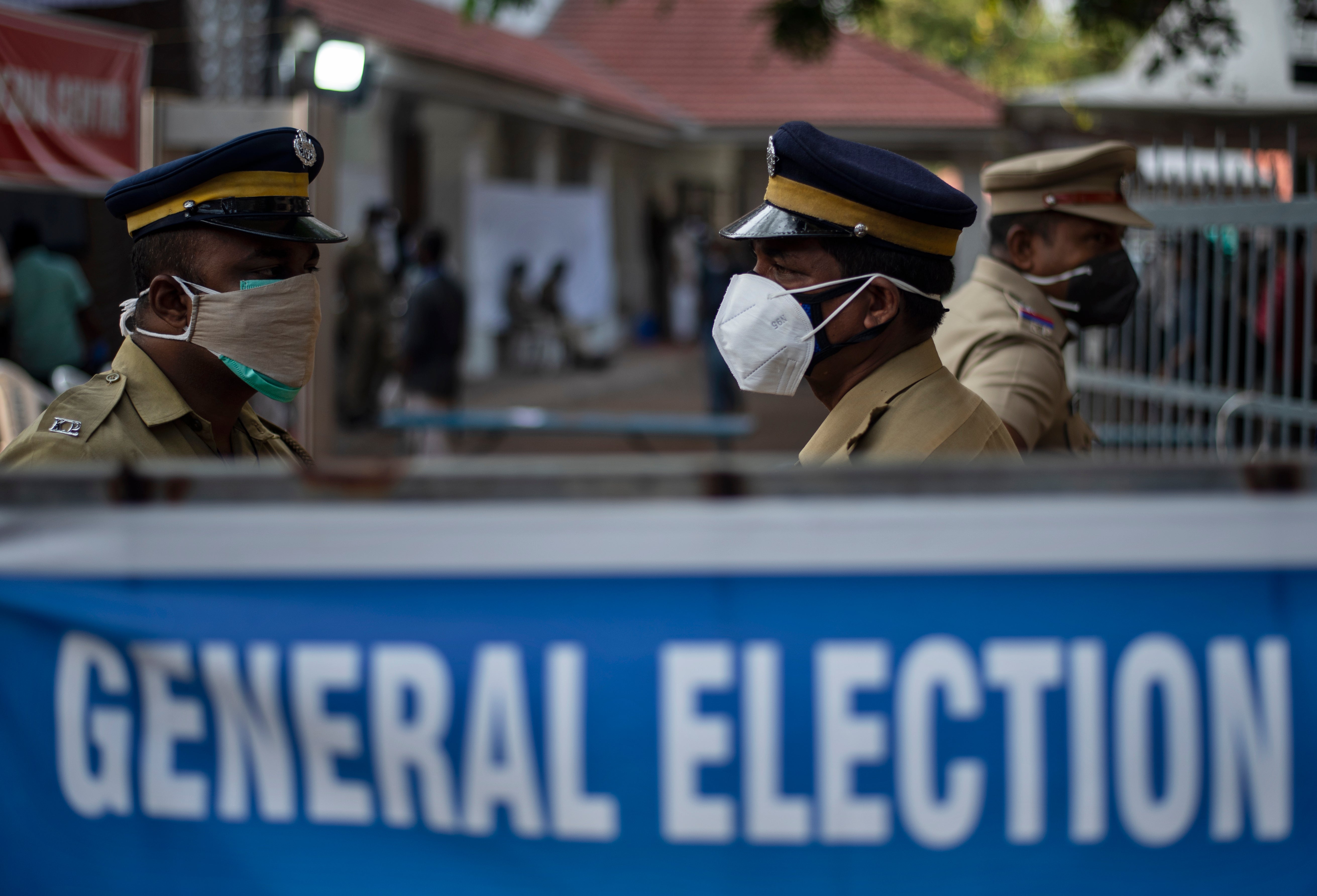 Police guard a vote-counting centre for the state legislature elections during a weekend lockdown in Kerala