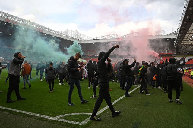 Manchester United fans protest on the pitch at Old Trafford