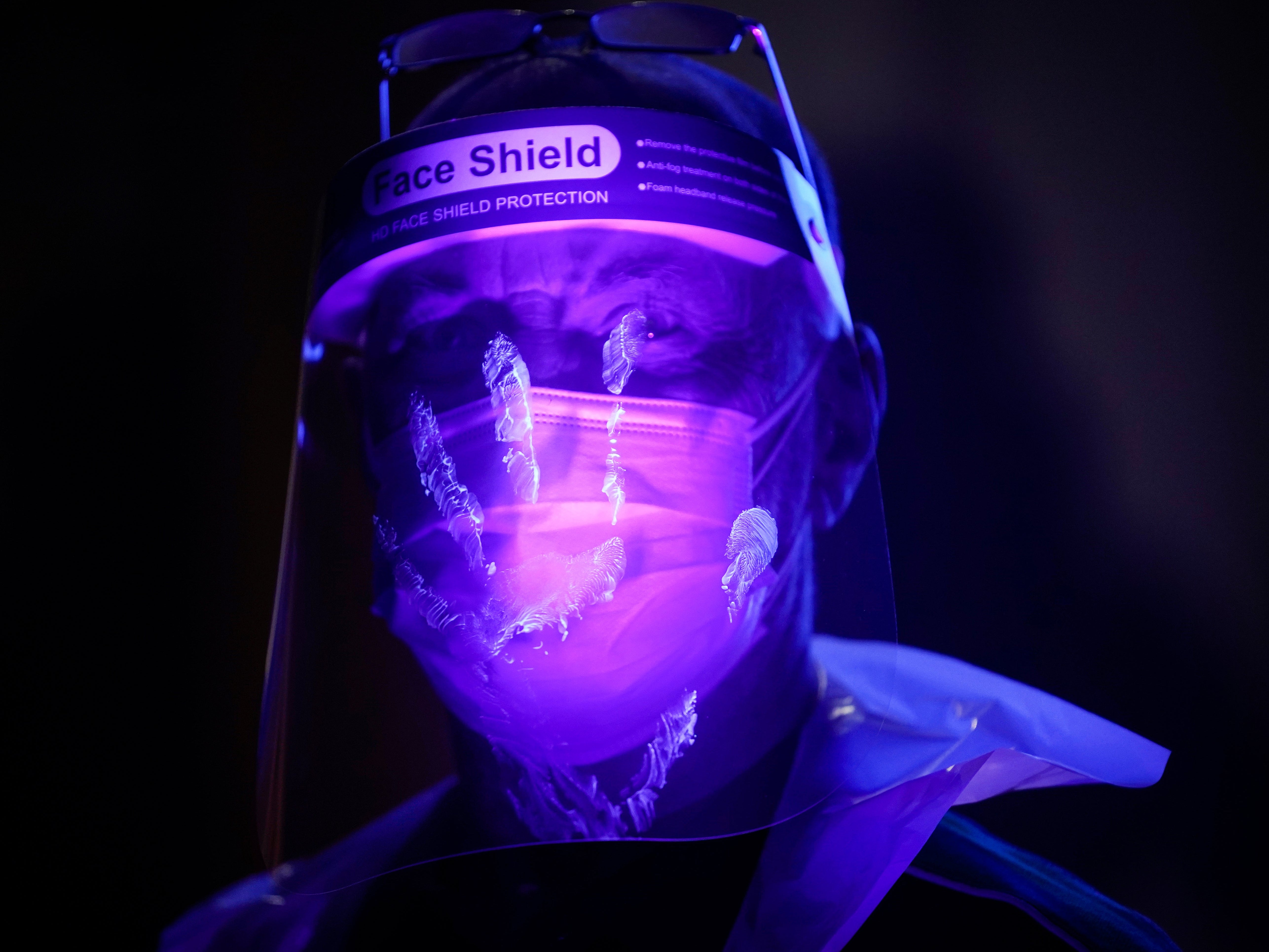 St John Ambulance instructor Keith Vickers is illuminated by ultra violet light to demonstrate how bacteria and contamination can be spread as he trains volunteers