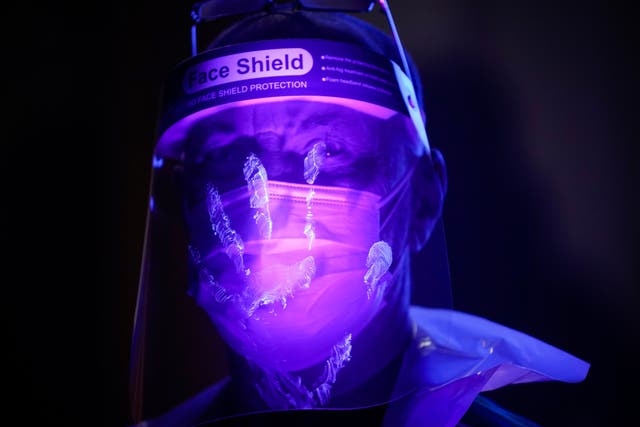 <p>St John Ambulance instructor Keith Vickers is illuminated by ultra violet light to demonstrate how bacteria and contamination can be spread as he trains volunteers</p>