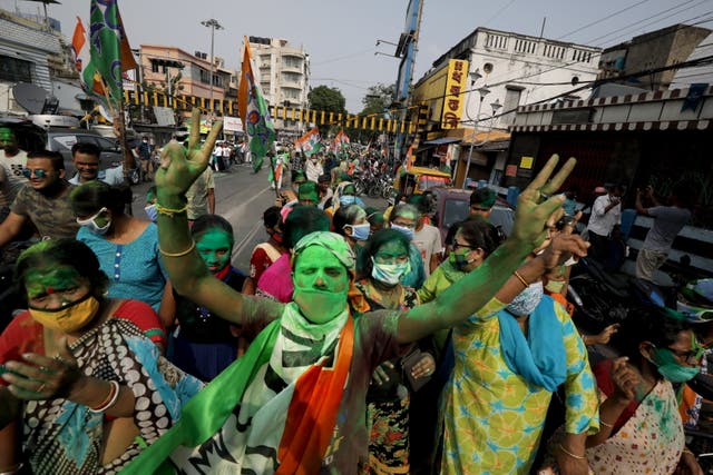<p>Trinamool Congress party (TMC) supporters celebrate after winning an absolute majority in the West Bengal Assembly Election in Kolkata, India, on 2 May 2021</p>