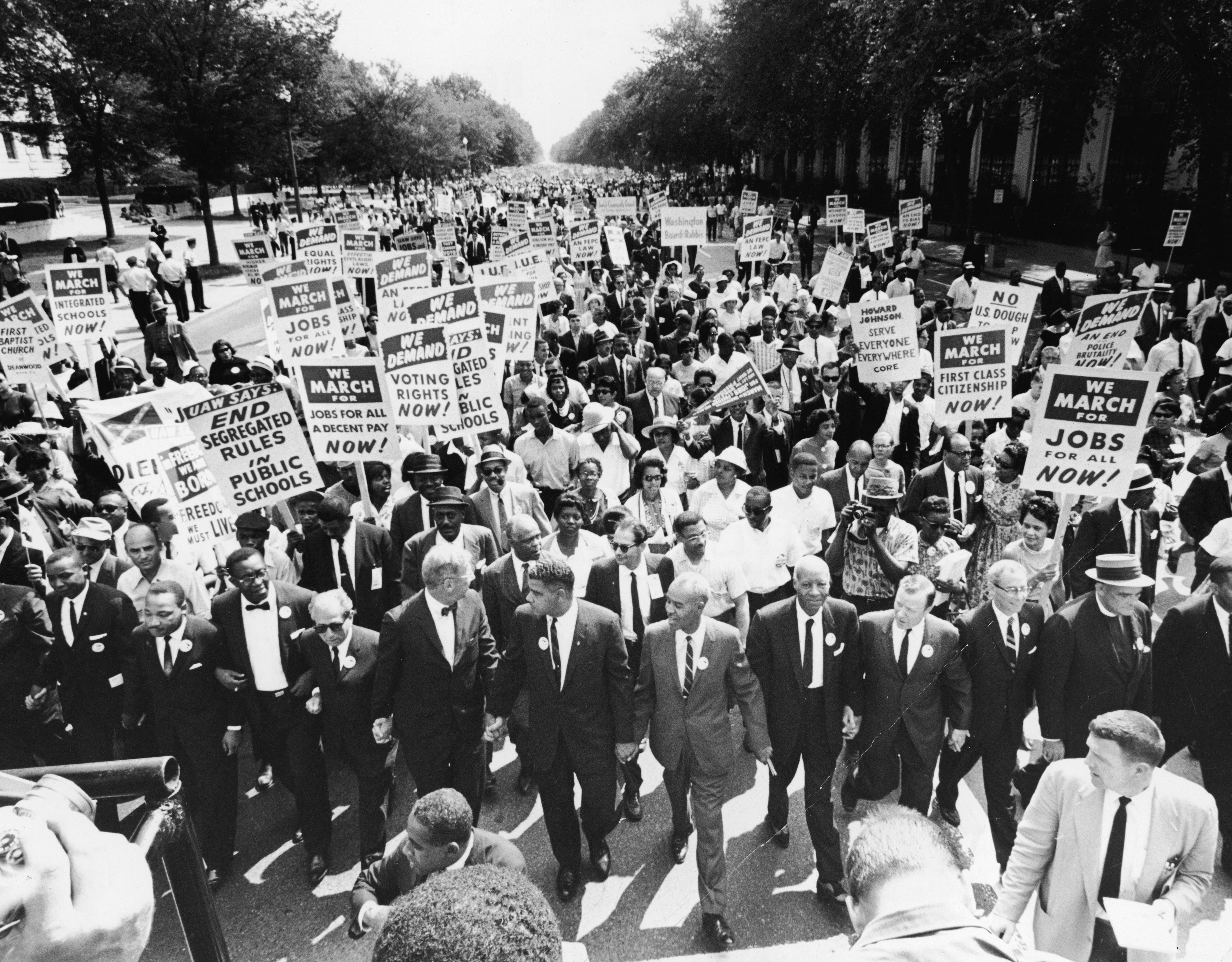 Civil rights leaders hold hands as they lead a crowd of hundreds of thousands at the March on Washington in 1963