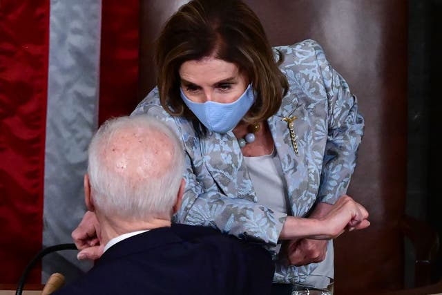 Speaker Nancy Pelosi and President Joe Biden bump elbows after he addressed a joint session of Congress on April 28, 2021. 