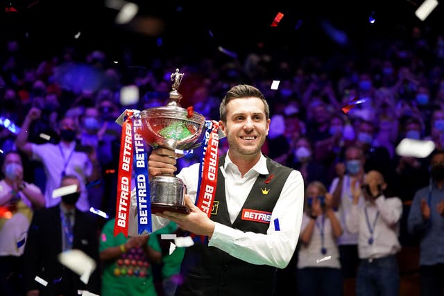 Mark Selby celebrates with the World Snooker Championship trophy