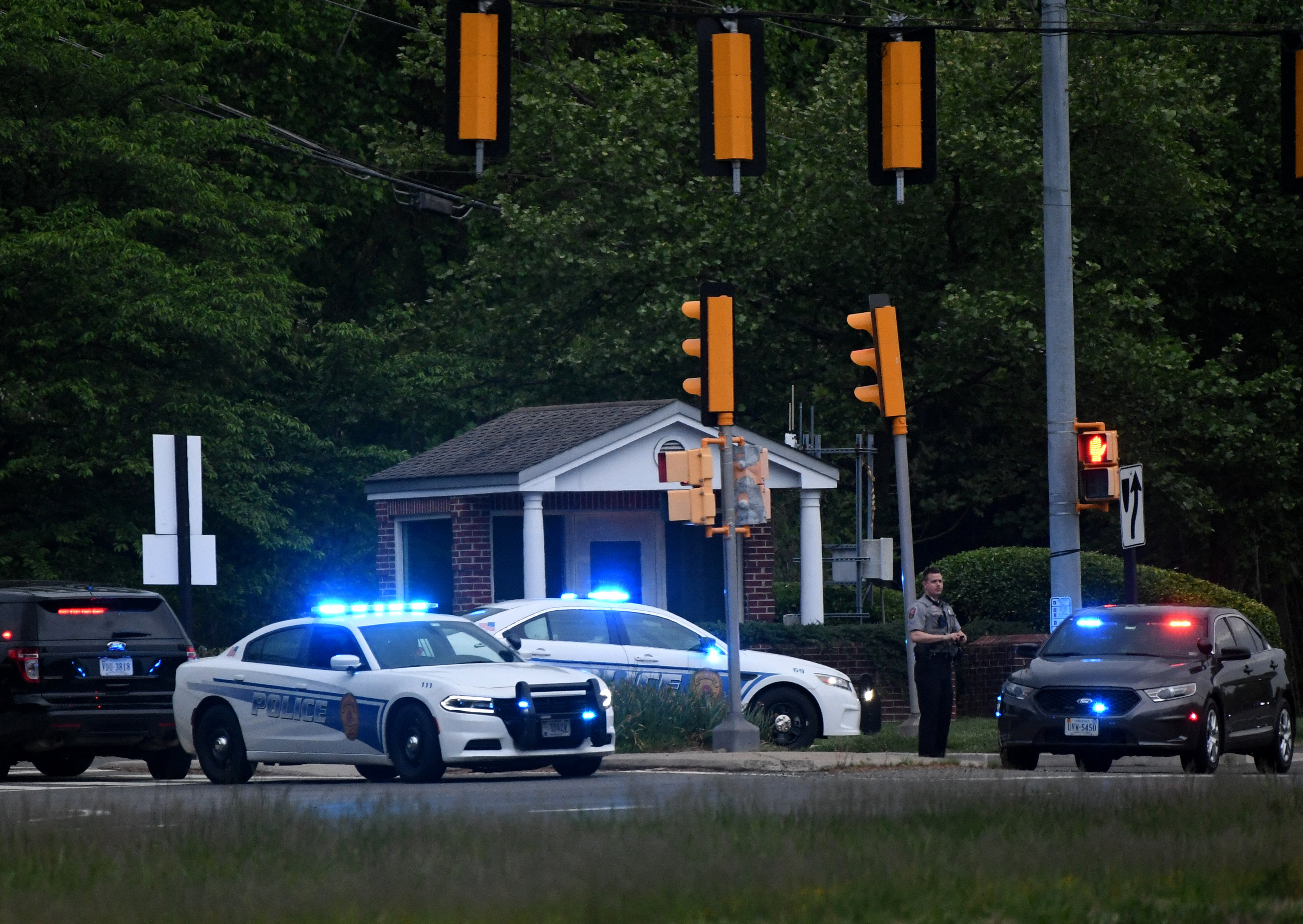 Police cars are seen outside the CIA headquarters's gate after an attempted intrusion earlier in the day in Langley, Virginia, on May 3, 2021