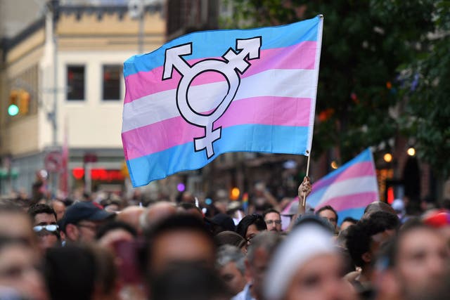 A transgender pride flag is held at a gathering in New York on 28 June, 2019. 